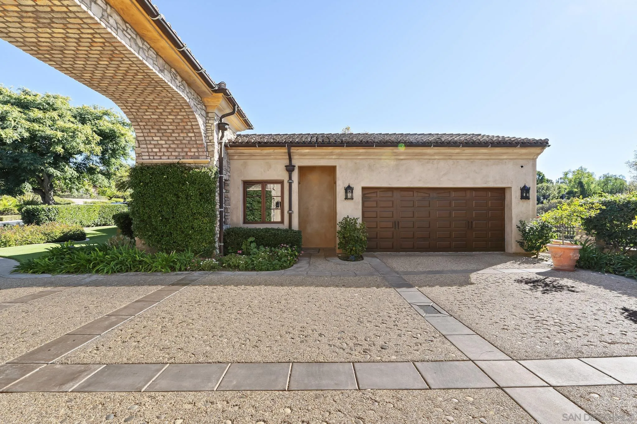18486 Via Candela Rancho Santa Fe, CA 92091 - Photo 31 of 34 a front view of a house with a yard and a garage