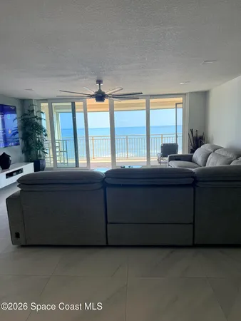 a bedroom with a large bed and a painting on the wall