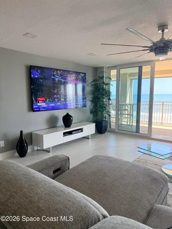 a spacious bedroom with a bed couch and a window