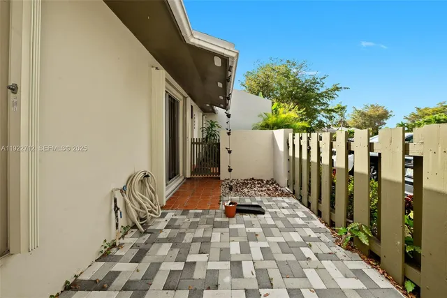 a view of a backyard with plants and a lake view