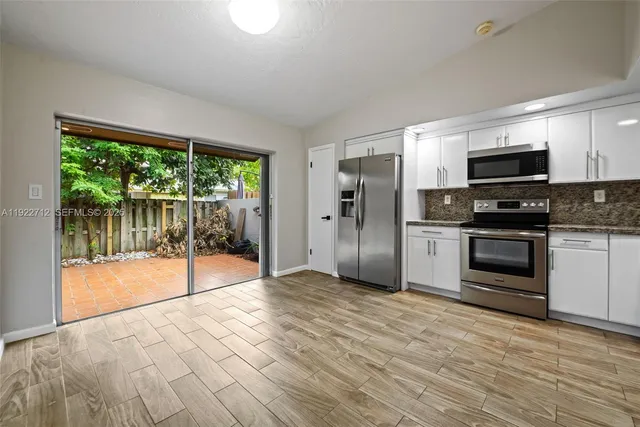 a kitchen with stainless steel appliances a refrigerator sink and stove