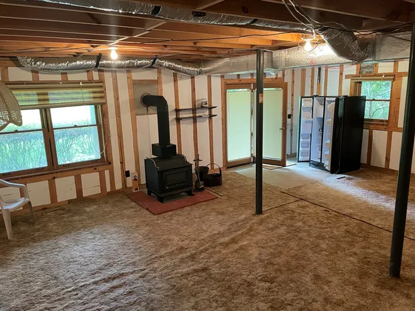 a living room with a fireplace furniture and a floor to ceiling window
