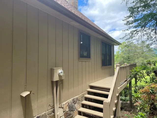 a front view of a house with a large window