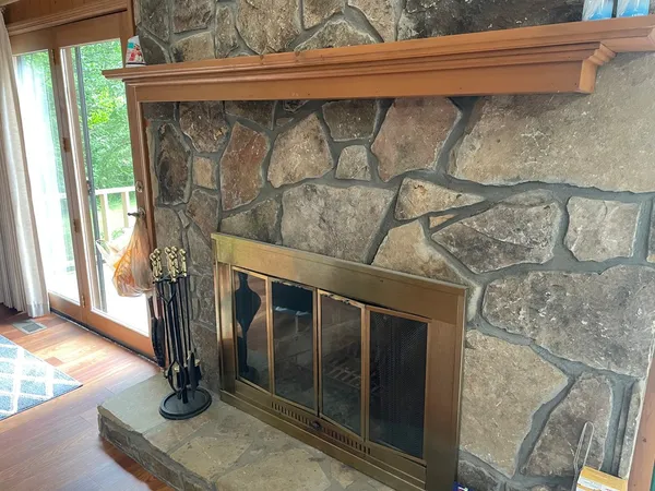a view of a porch with furniture and a floor to ceiling window
