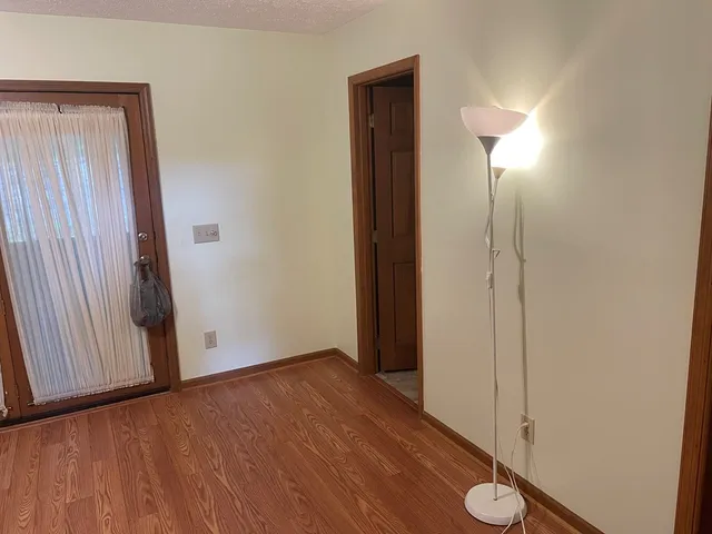 a view of a bathroom with wooden floor and mirror