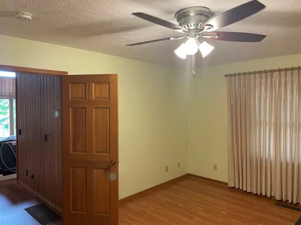 a view of a livingroom with a chandelier fan