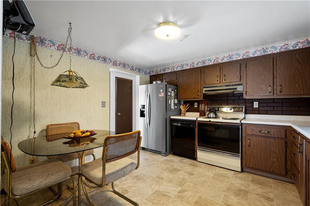 3157 Old Oakdale Road McDonald, PA 15057 - Photo 12 of 39 a kitchen with stainless steel appliances granite countertop a stove and a refrigerator