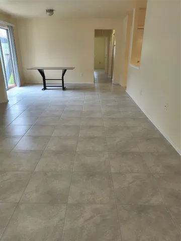 a view of a livingroom with a staircase and a projector screen