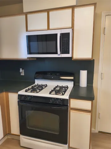 a stove top oven sitting inside of a kitchen