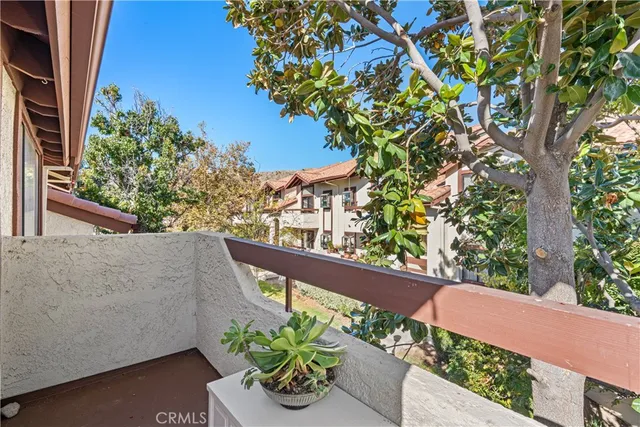 a front view of a house with swimming pool having outdoor seating