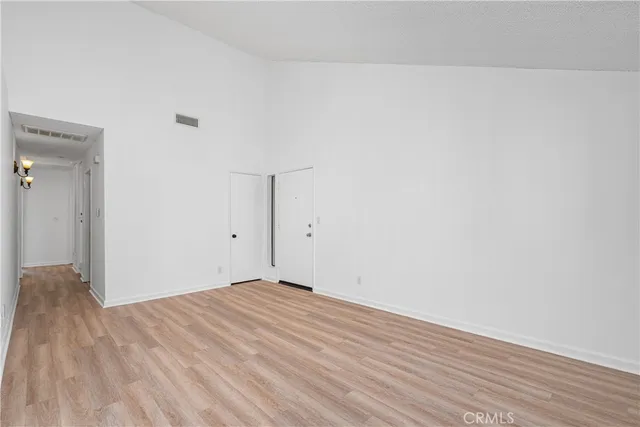 a view of a kitchen with wooden floor and a ceiling fan
