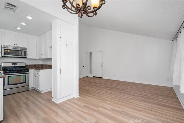 a kitchen with sink a stove and cabinets