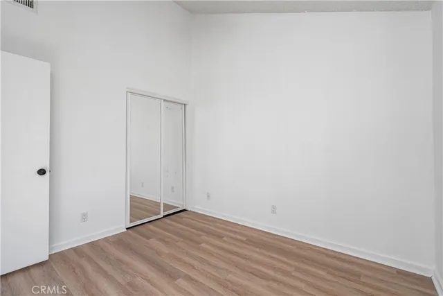 an empty room with a window and a ceiling fan