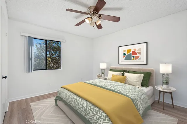 a bedroom with a bed and a painting on the wall