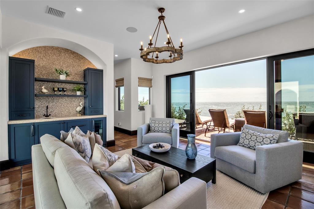 121 North Casey Key Road Osprey, FL 34229 - Photo 5 of 63 a living room with furniture chandelier and a large window