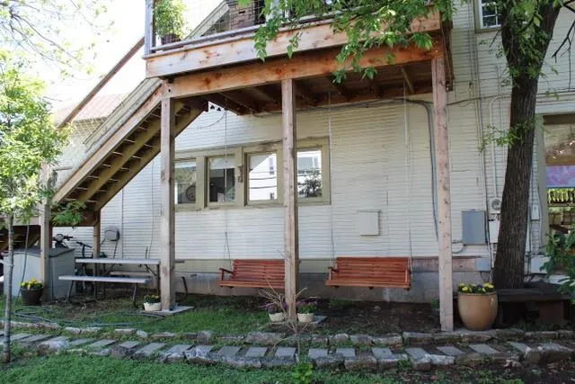 a backyard of a house with barbeque oven