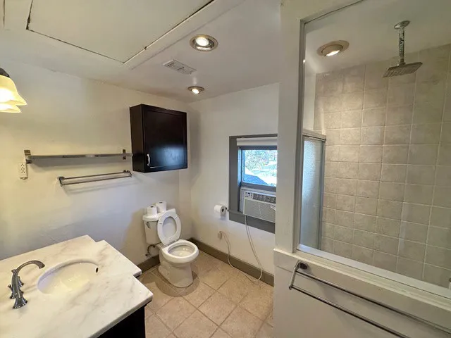 a bathroom with a sink toilet and shower
