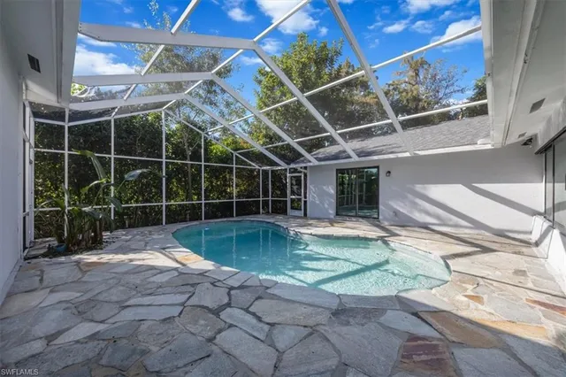 a view of a backyard with a swimming pool