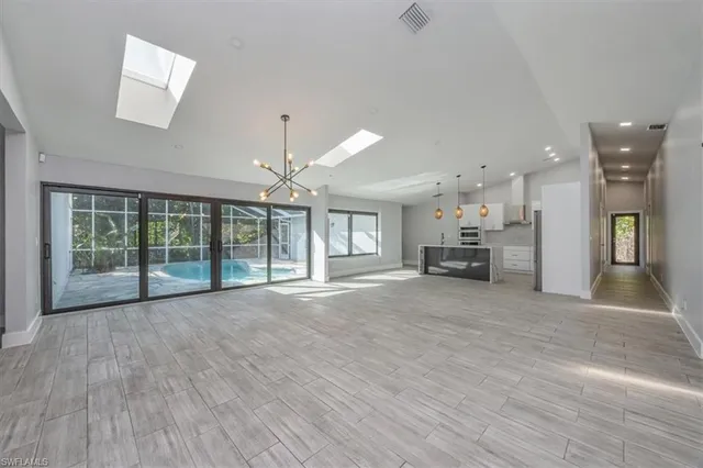 a view of livingroom with furniture and a kitchen