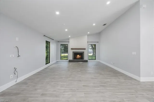 a view of an empty room with a fireplace