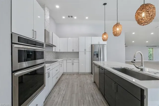 a kitchen with stainless steel appliances granite countertop a stove oven and a sink