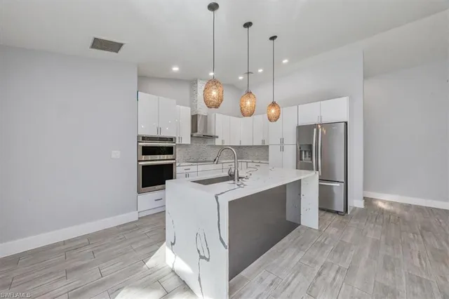 a large kitchen with stainless steel appliances kitchen island a large island in the center