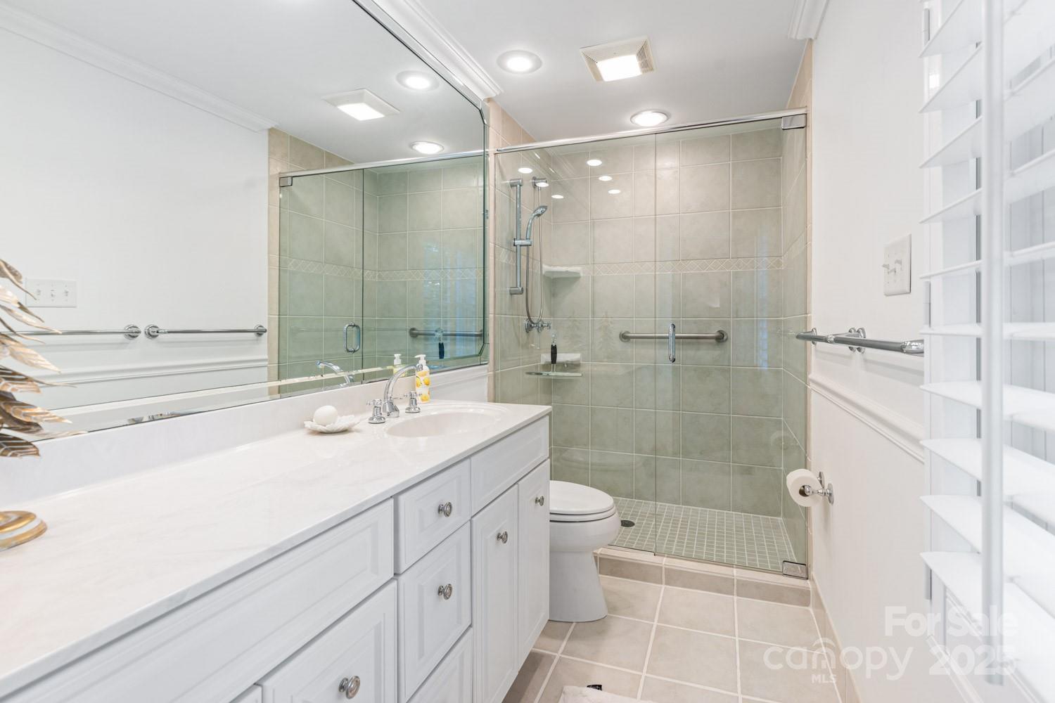 15 Busbee Road Biltmore Forest, NC 28803 - Photo 15 of 24 a bathroom with a shower sink vanity mirror and bathtub