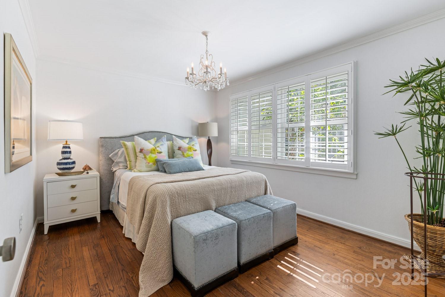 15 Busbee Road Biltmore Forest, NC 28803 - Photo 16 of 24 a bedroom with a bed and a chandelier
