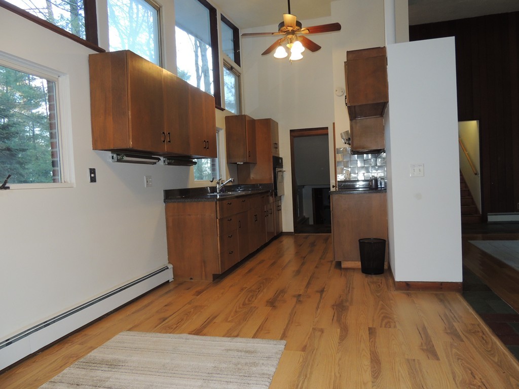 25 Algonquin Road Canton, MA 02021 - Photo 3 of 9 a kitchen with stainless steel appliances granite countertop a refrigerator a stove and a wooden floors