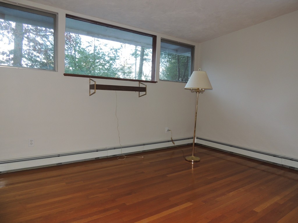 25 Algonquin Road Canton, MA 02021 - Photo 7 of 9 a view of a room with wooden floor and large window