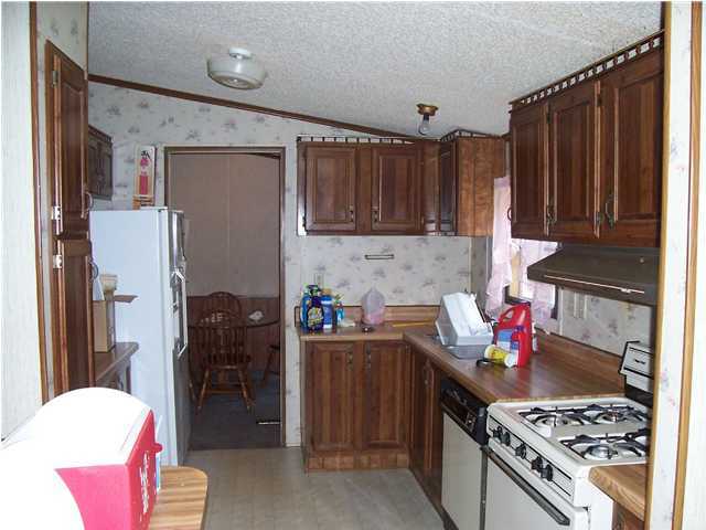 6111 Old Hickory Road Crestview, FL 32539 - Photo 3 of 4 a kitchen with stainless steel appliances granite countertop a stove refrigerator and a sink