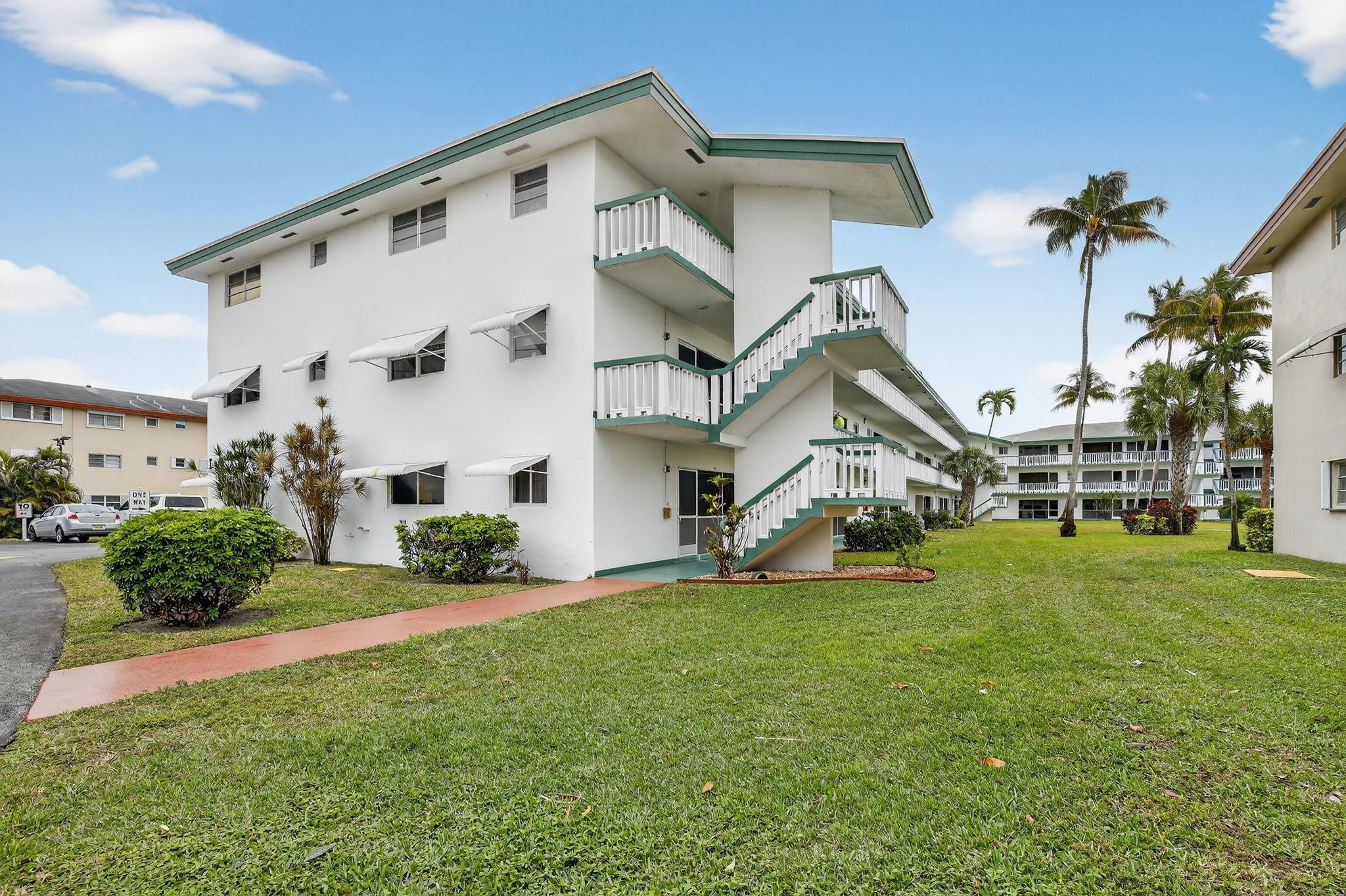 5300 Washington Street, Unit I201 Hollywood, FL 33021 - Photo 25 of 35 a front view of a house with a yard and garage