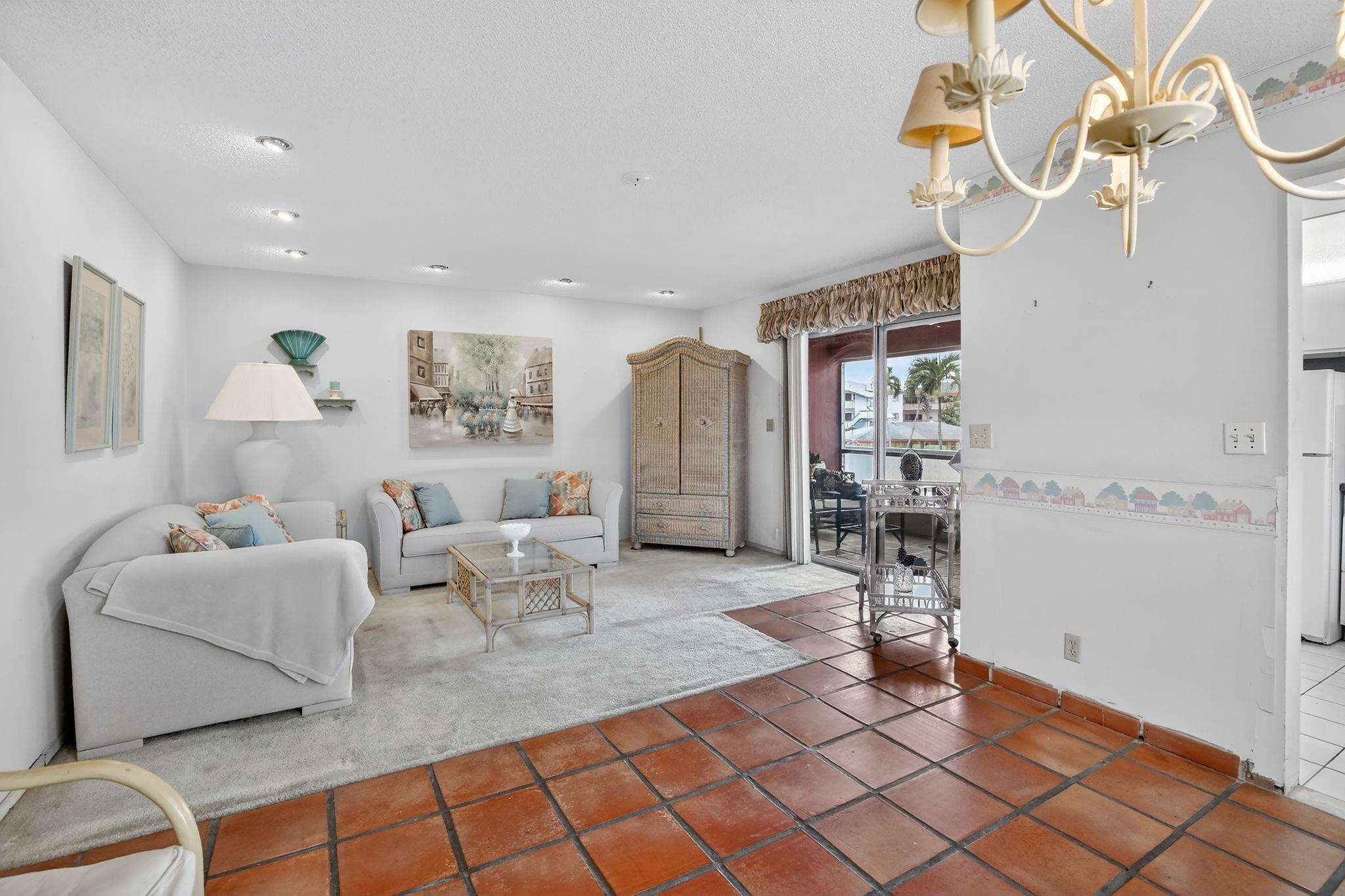 5300 Washington Street, Unit I201 Hollywood, FL 33021 - Photo 3 of 35 a living room with furniture a dining table and a chandelier