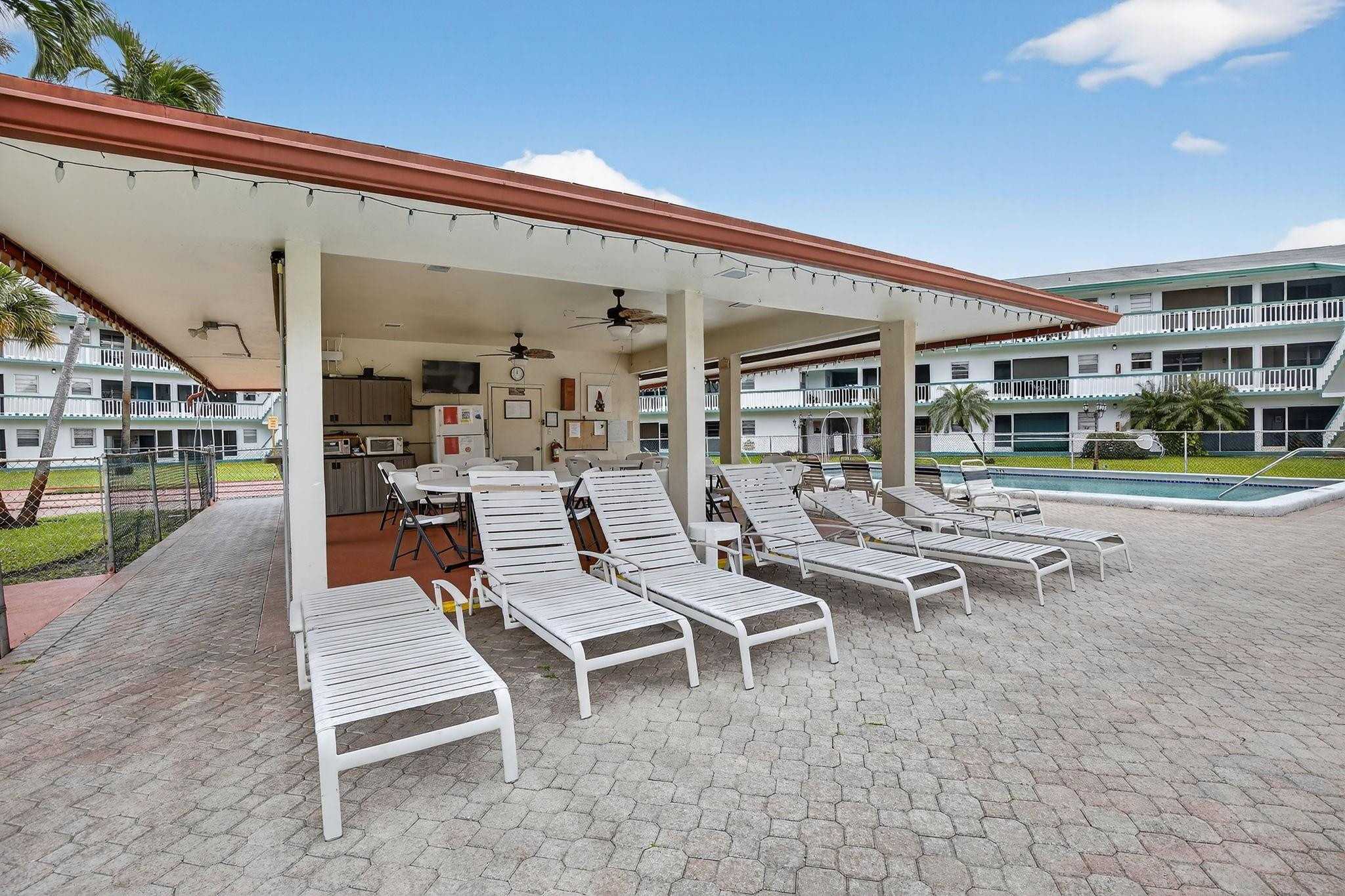 5300 Washington Street, Unit I201 Hollywood, FL 33021 - Photo 33 of 35 a view of a patio with a table and chairs and potted plants