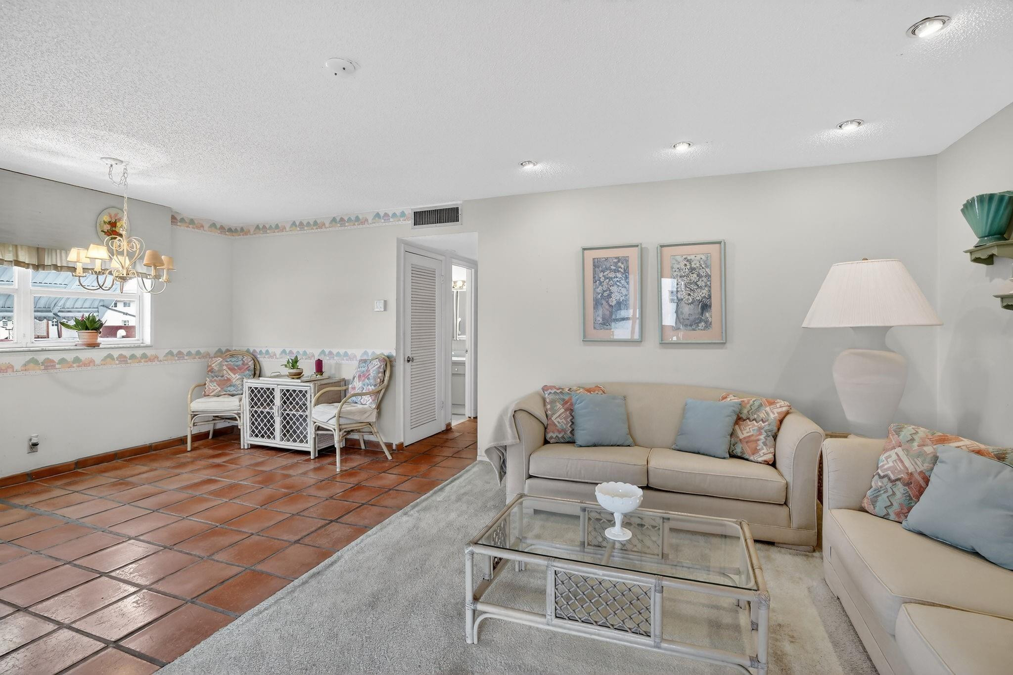 5300 Washington Street, Unit I201 Hollywood, FL 33021 - Photo 4 of 35 a living room with furniture and a lamp