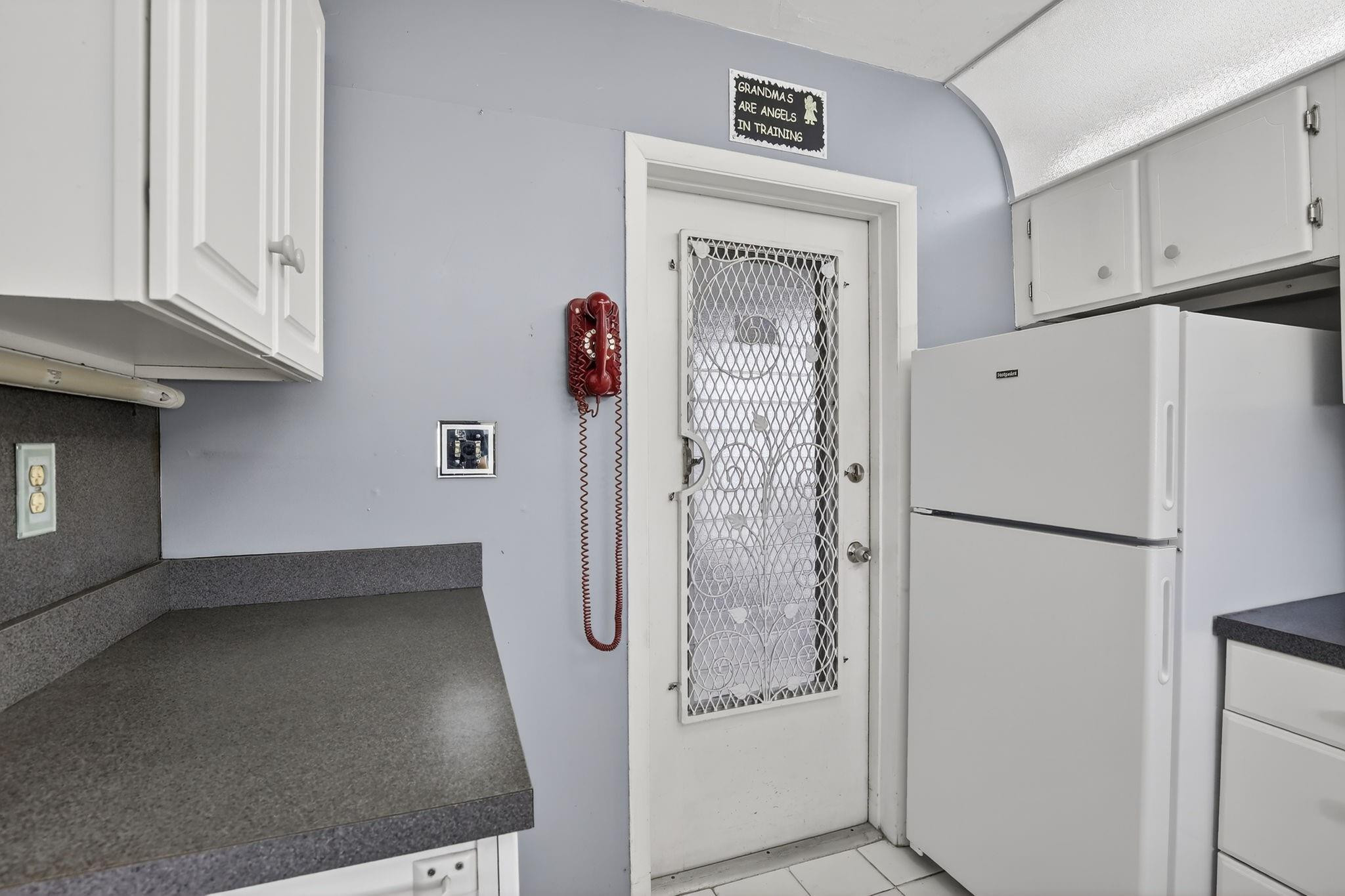 5300 Washington Street, Unit I201 Hollywood, FL 33021 - Photo 9 of 35 a white refrigerator freezer sitting inside of a kitchen