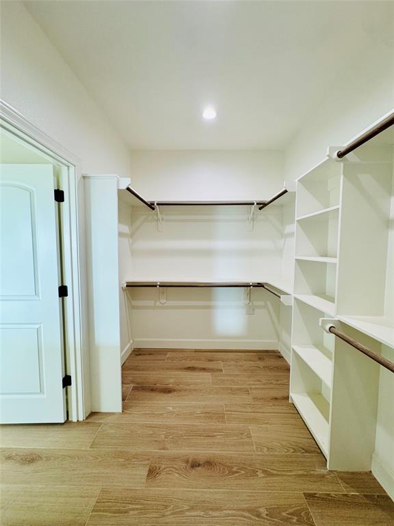 245 Indian Ridge Road Tuscola, TX 79562 - Photo 13 of 21 Walk in closet featuring wood finish floors