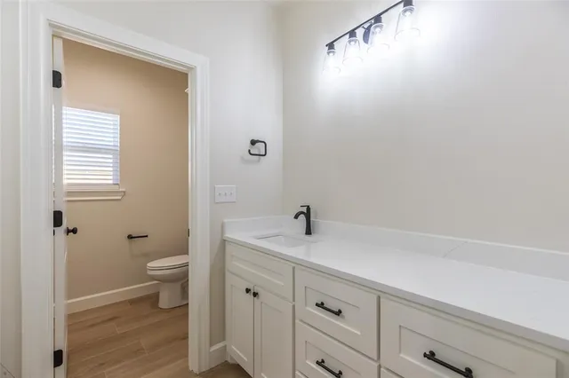 a view of bathroom with a sink mirror and toilet