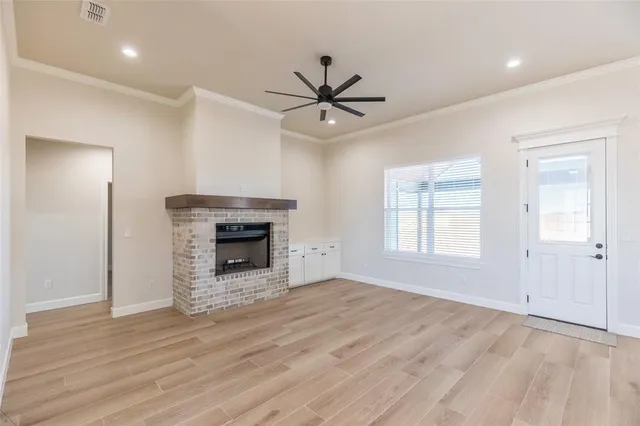 an empty room with windows and a fireplace
