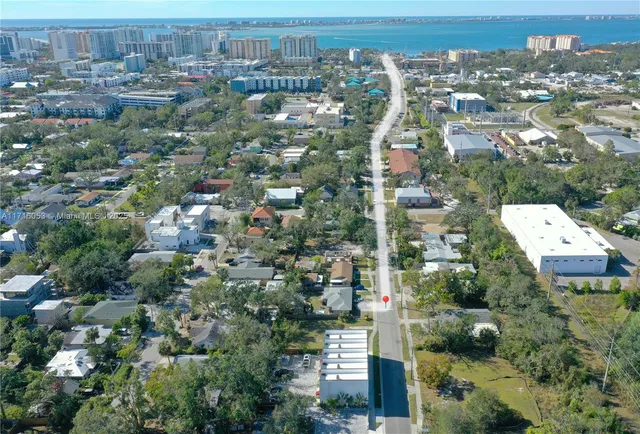an aerial view of a house with a yard basket ball court and outdoor seating