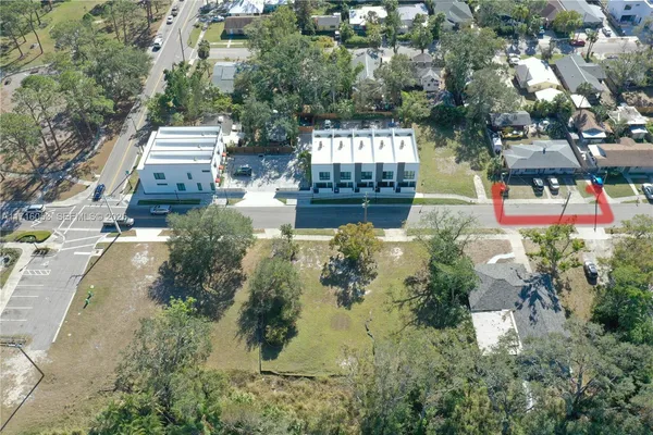 an aerial view of a house with a yard basket ball court and outdoor seating