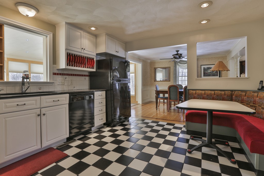 1 Carleton Road Groveland, MA 01834 - Photo 13 of 30 a kitchen with a checkered floor and white cabinets