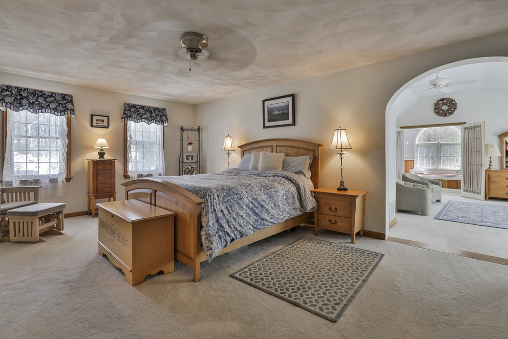 1 Carleton Road Groveland, MA 01834 - Photo 23 of 30 a spacious bedroom with a bed a couch and dresser