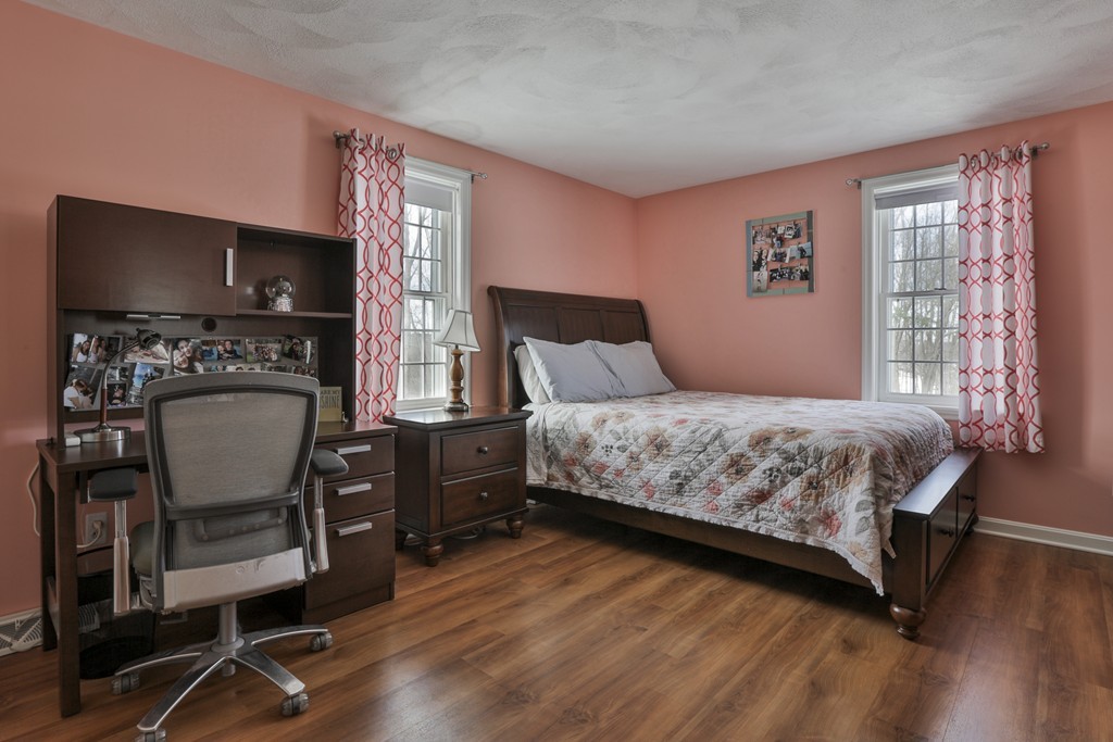 1 Carleton Road Groveland, MA 01834 - Photo 27 of 30 a bedroom with a bed a chair a computers on the table and a window