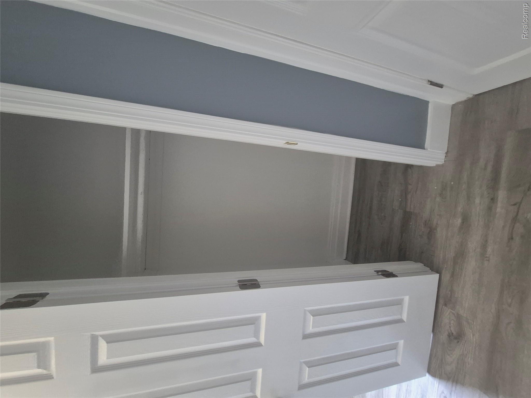16758 Frazho Road Roseville, MI 48066 - Photo 44 of 53 Closet space with hanging rod and wood-finish flooring