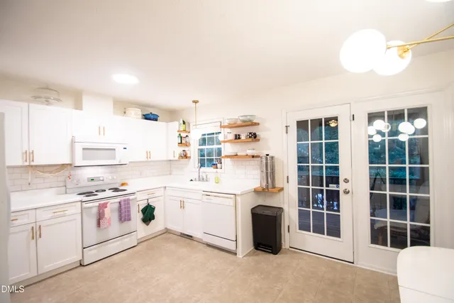 a kitchen with cabinets and window