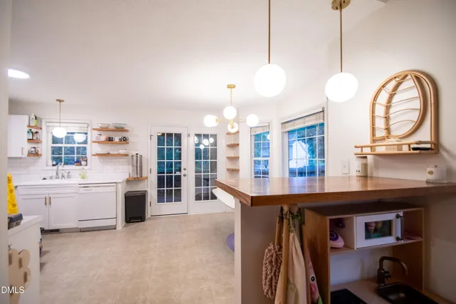 a kitchen with kitchen island a stove a center island and a refrigerator