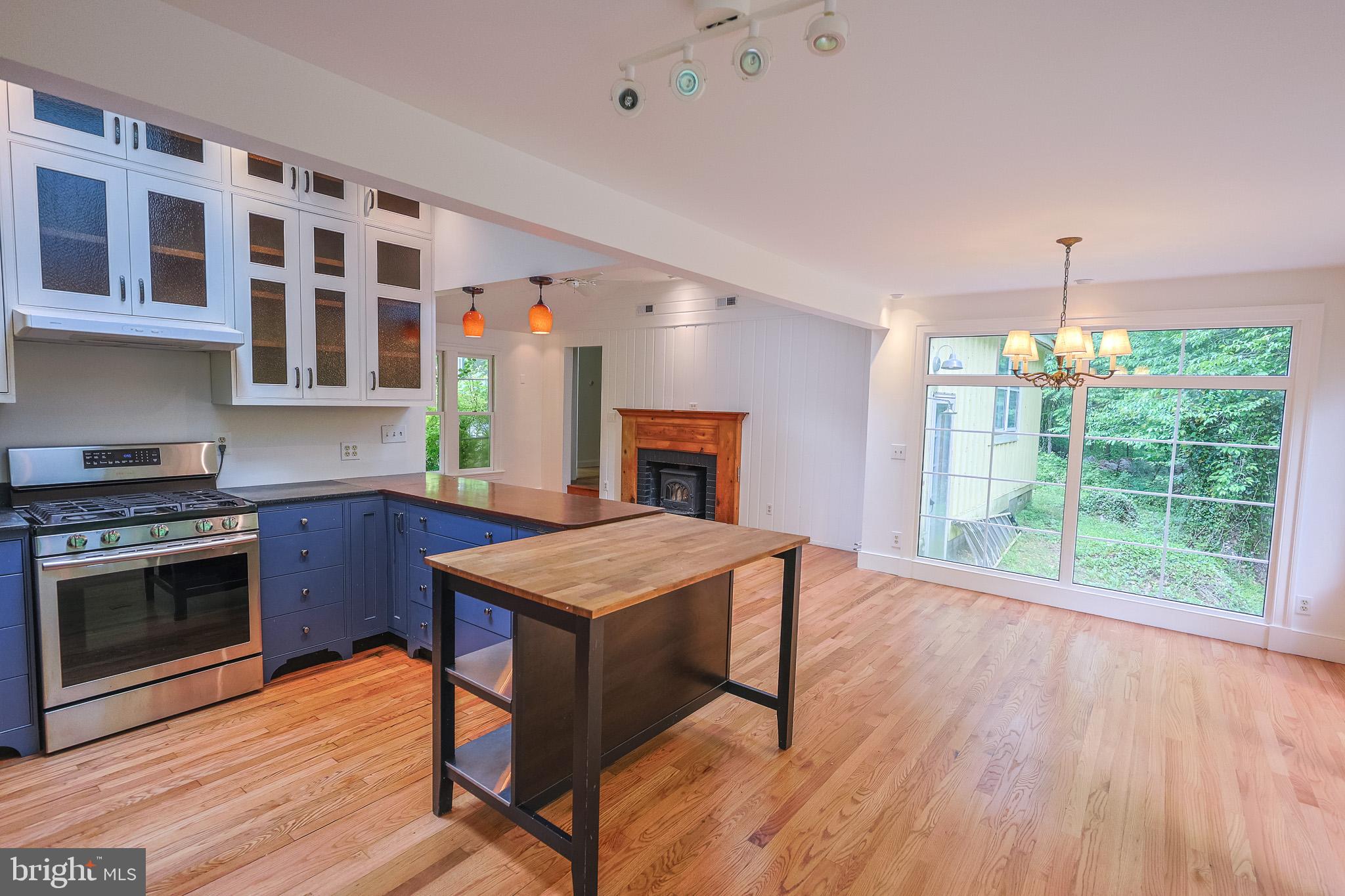 98 Swindler Hollow Road Sperryville, VA 22740 - Photo 5 of 25 a kitchen that has a microwave a stove and wooden floor