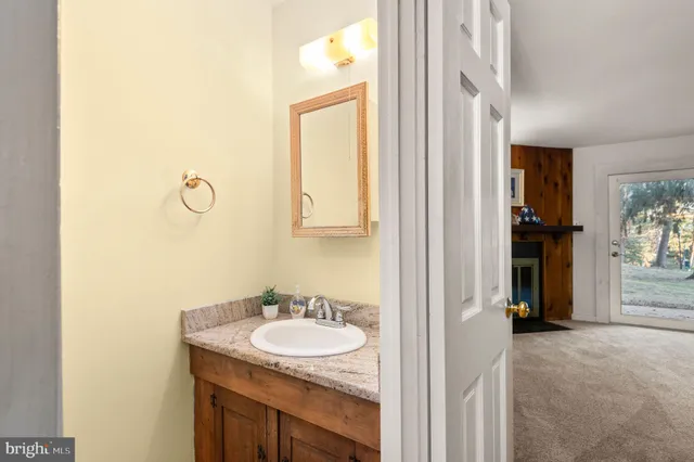 a bathroom with a granite countertop sink and a mirror