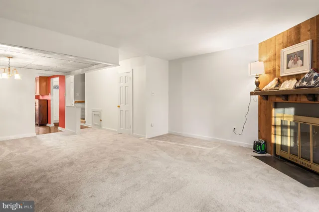 a view of an empty room with a fireplace